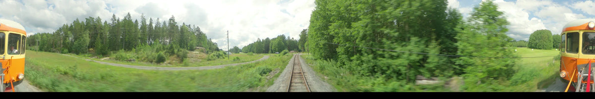 View from a train moving through a lush green forest in Uppsala, Sweden, on a partly cloudy summer afternoon. A blue car is parked by a side road.