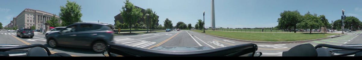 Daytime car drive through Washington, United States, during a clear spring day. The view includes the Washington Monument and the Vietnam Veterans Memorial.