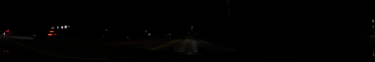 Clear spring night driving footage from a car in Washington, United States. The dark road is marked by double yellow lines and scattered distant lights.